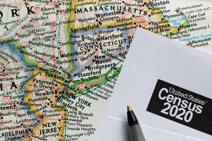 A map of the northeast, with New York at the center, next to a U.S. Census form for 2020